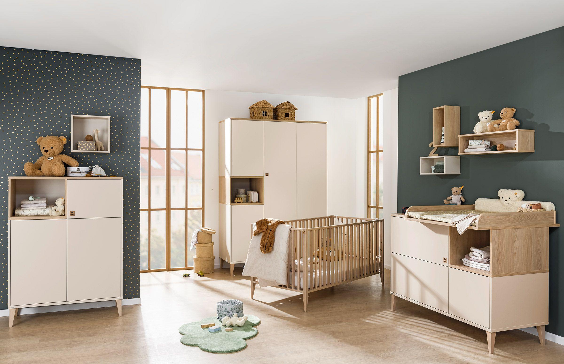 Helles Babyzimmer mit Holz- und Creme-Elementen, Gitterbett, Wickelkommode, Kleiderschrank und liebevoller Deko – gemütlich und funktional eingerichtet.